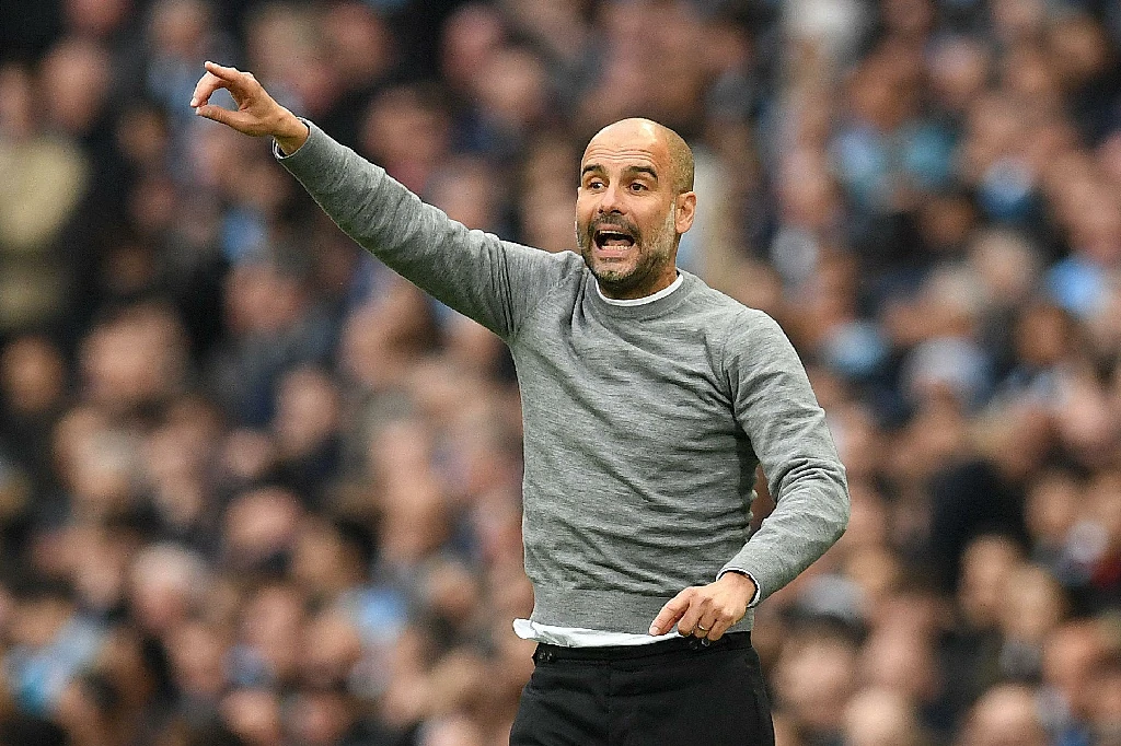 Pep Guardiola coaching Manchester City during a Premier League match